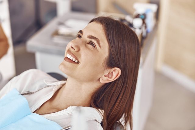Smiling patient in dental chair during restorative dentistry consultation at Algoma Family Dentistry.